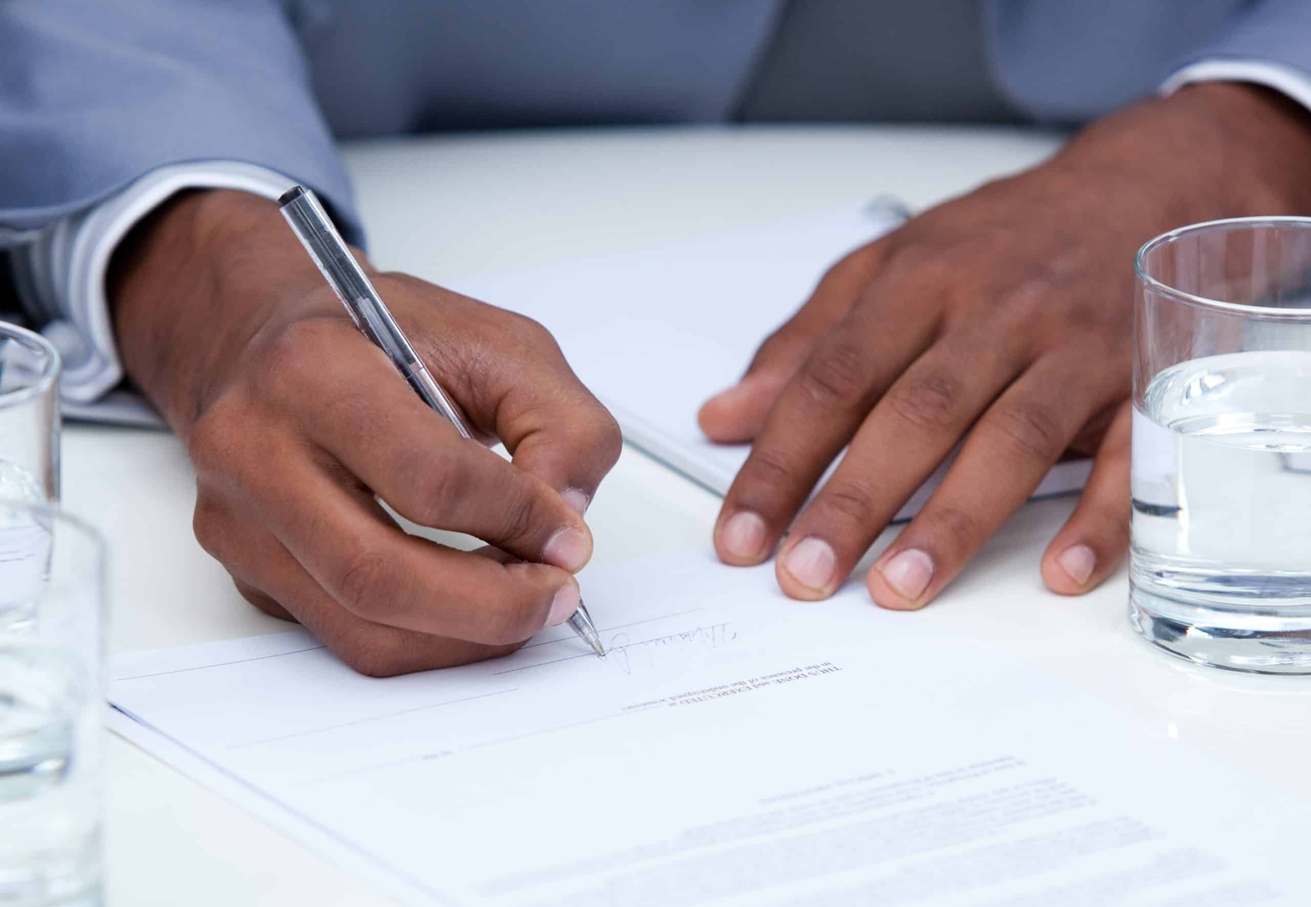 A man signs legal documents